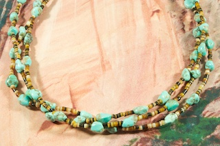 Beautiful 3 strand Necklace featuring Genuine Kingman Turquoise with accents of Penshell Heishi. Sterling Silver Cones and Clasp. Created by Santo Domingo Artist Carol Pacheco. The Santo Domingo Pueblo is in New Mexico, near Santa Fe.